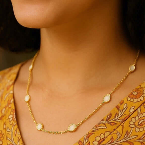 Moon Mama Short - Mother of Pearl Necklace showcased on a model wearing a floral dress, highlighting its delicate design.