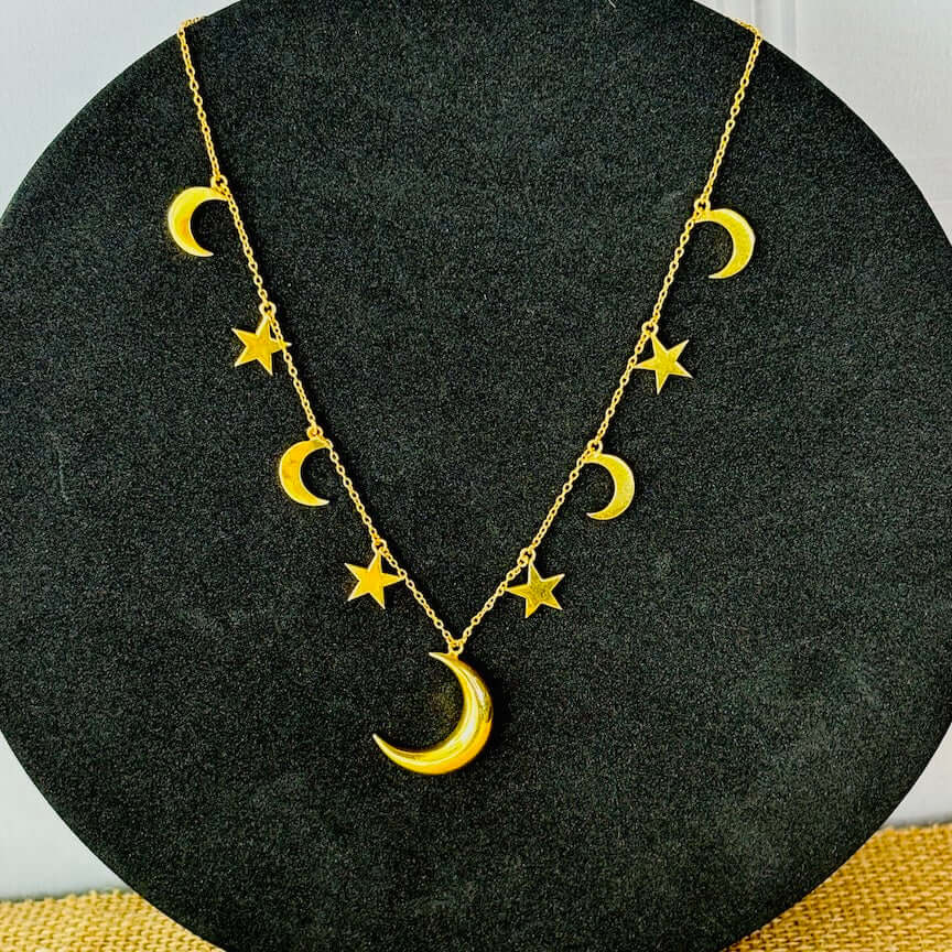 moon and star statement necklace against a studio black backdrop