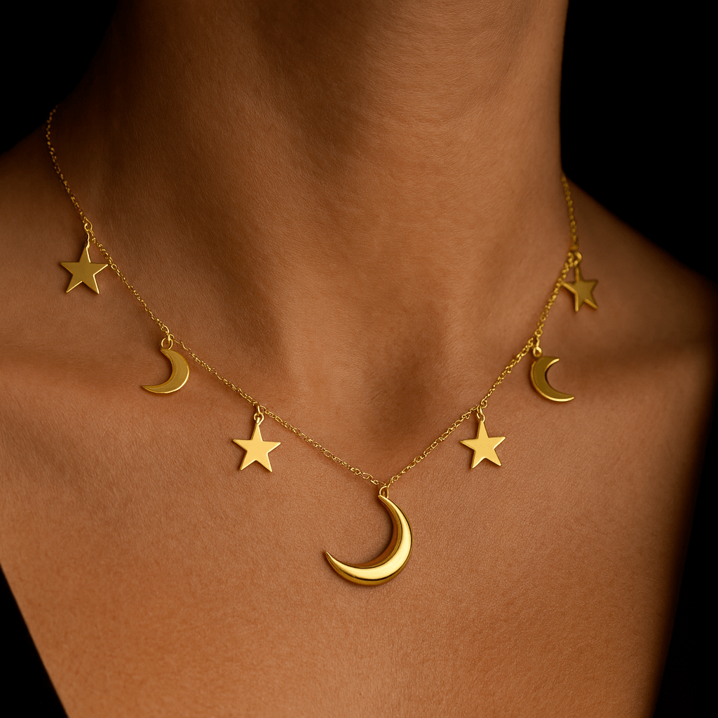 Gold necklace with star and moon pendants on a person's neck against a dark background