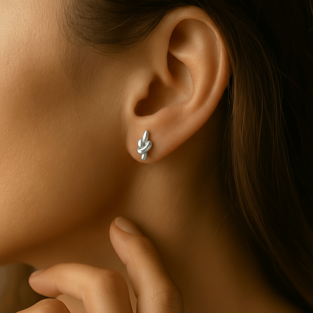 Close-up of a person wearing Knot Earring Studs with a blurred background