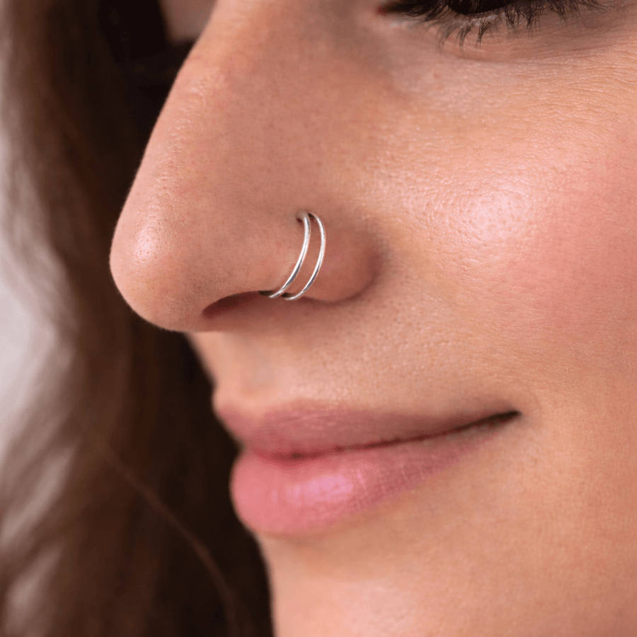 Model wearing The Reya Double Band Nose Ring made of 92.5 sterling silver, highlighting its layered design.