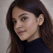 Close-up of a model wearing The Reya Double Band Nose Ring, showcasing its layered design and comfortable fit.