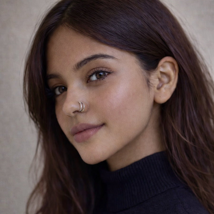 Close-up of a model wearing The Reya Double Band Nose Ring, showcasing its layered design and comfortable fit.
