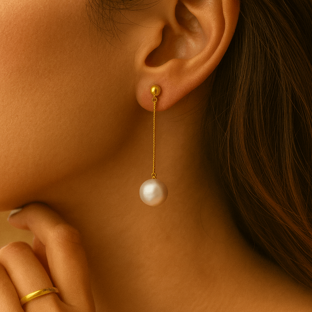 Pearl Drop Earrings featuring a delicate design with a pearl dangling from a gold vermeil chain.