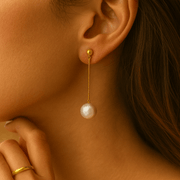 Pearl Drop Earrings featuring a delicate design with a pearl dangling from a gold vermeil chain.