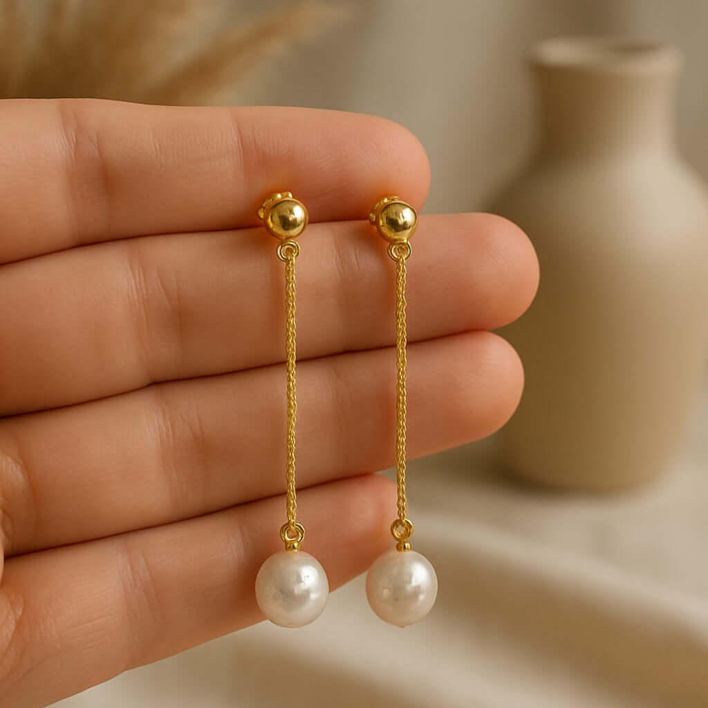 Pearl Drop Earrings featuring a delicate design with a pearl dangling from a gold vermeil chain.