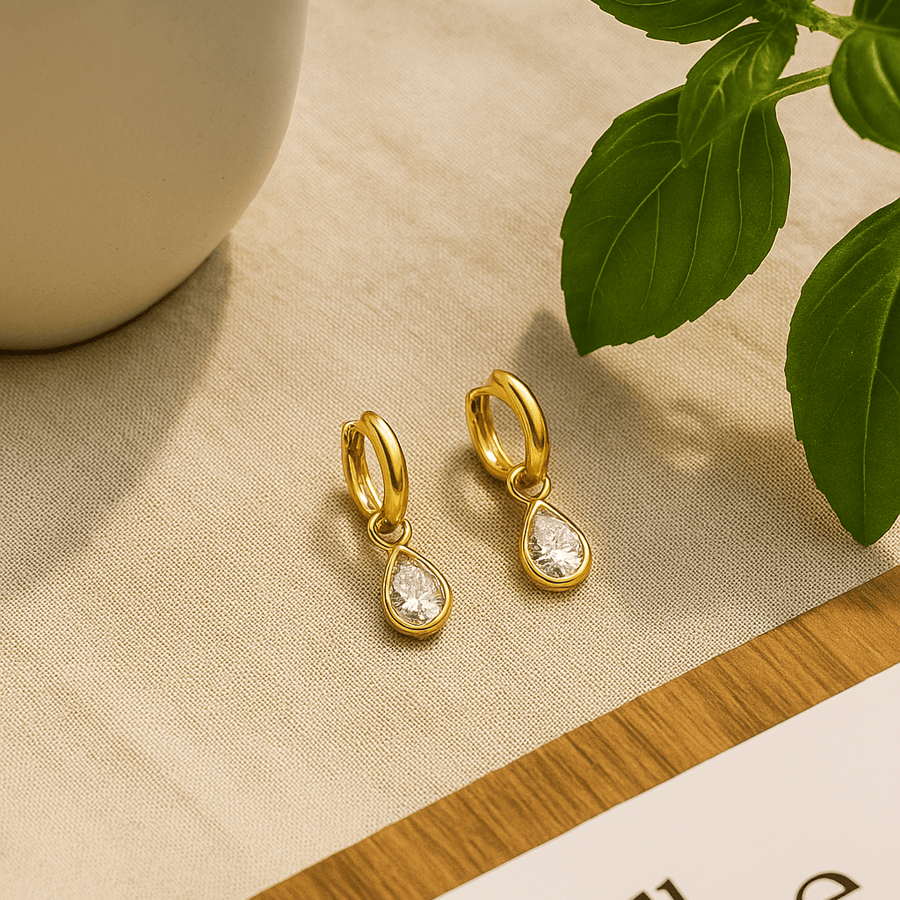 Diamond Dew Drops earrings featuring teardrop-cut cubic zircon set in gold vermeil against a neutral background.