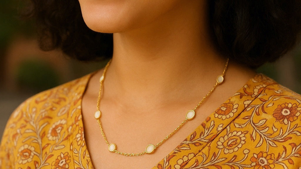 Woman wearing a yellow patterned top with a blurred background