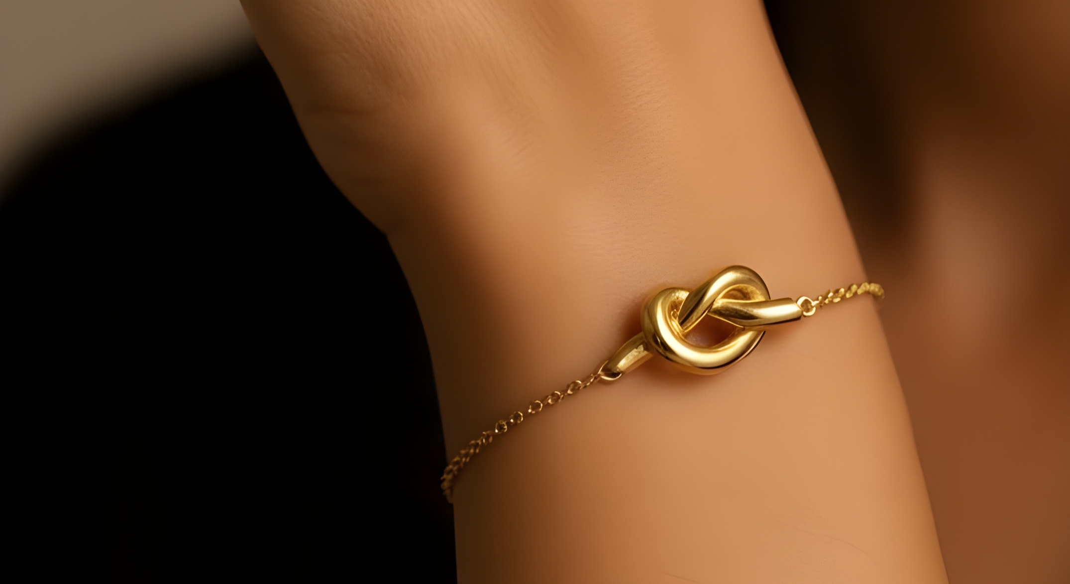 Gold bracelet on a wrist with a blurred background