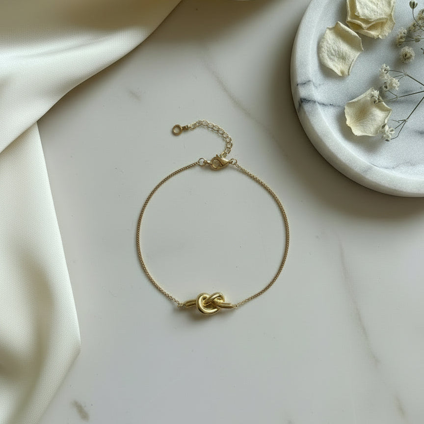 The Knot Bracelet showcasing a clean knot detail, crafted in 925 sterling silver with 18K gold vermeil.
