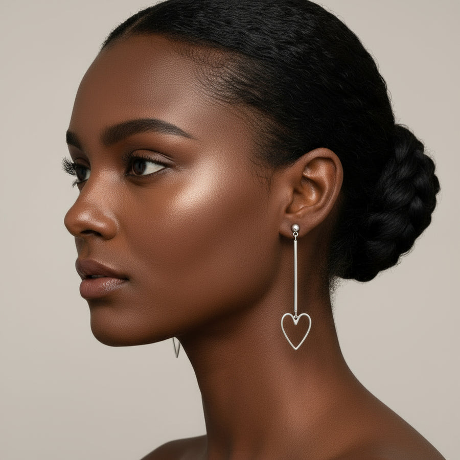 Silver heart-shaped earrings worn by a model
