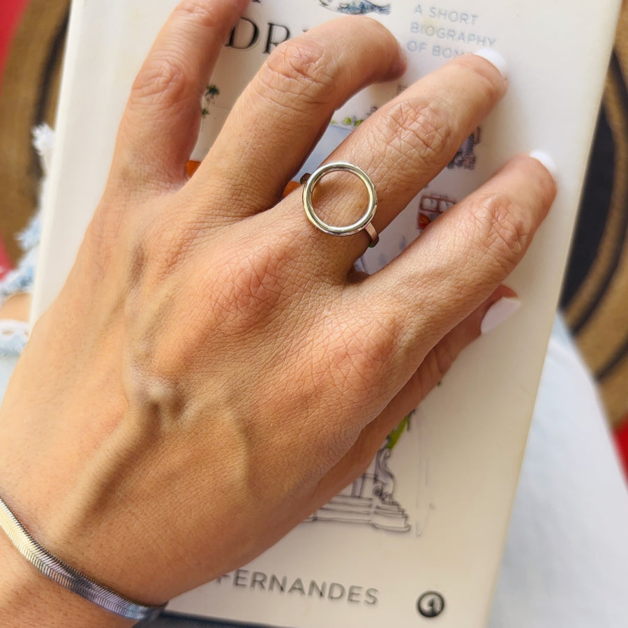 Hand wearing a silver ring on a book