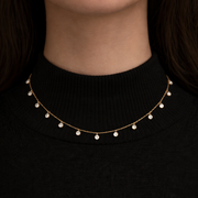 Celeste Diamond Necklace worn on a black turtleneck, featuring high-grade cubic zircon diamonds on a delicate chain.