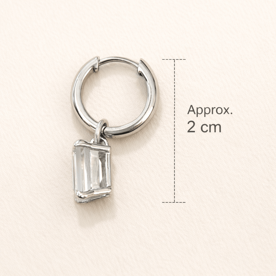 Everyday diamond earrings featuring a single solitaire high-grade cubic zircon diamond on a silver hoop.