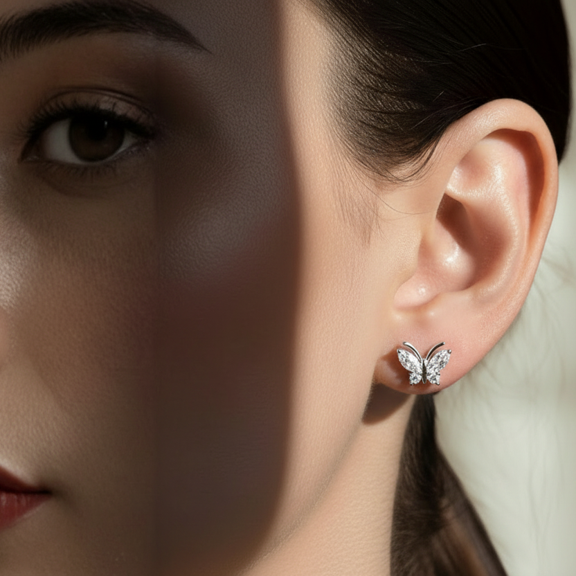 Isla Butterfly Diamond Stud Earrings showcased on a model, highlighting their elegant butterfly design in sterling silver.