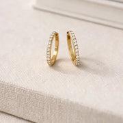 Everyday Diamond Huggies showcasing sparkly hoops with tiny cubic zirconia stones for a subtle shine.
