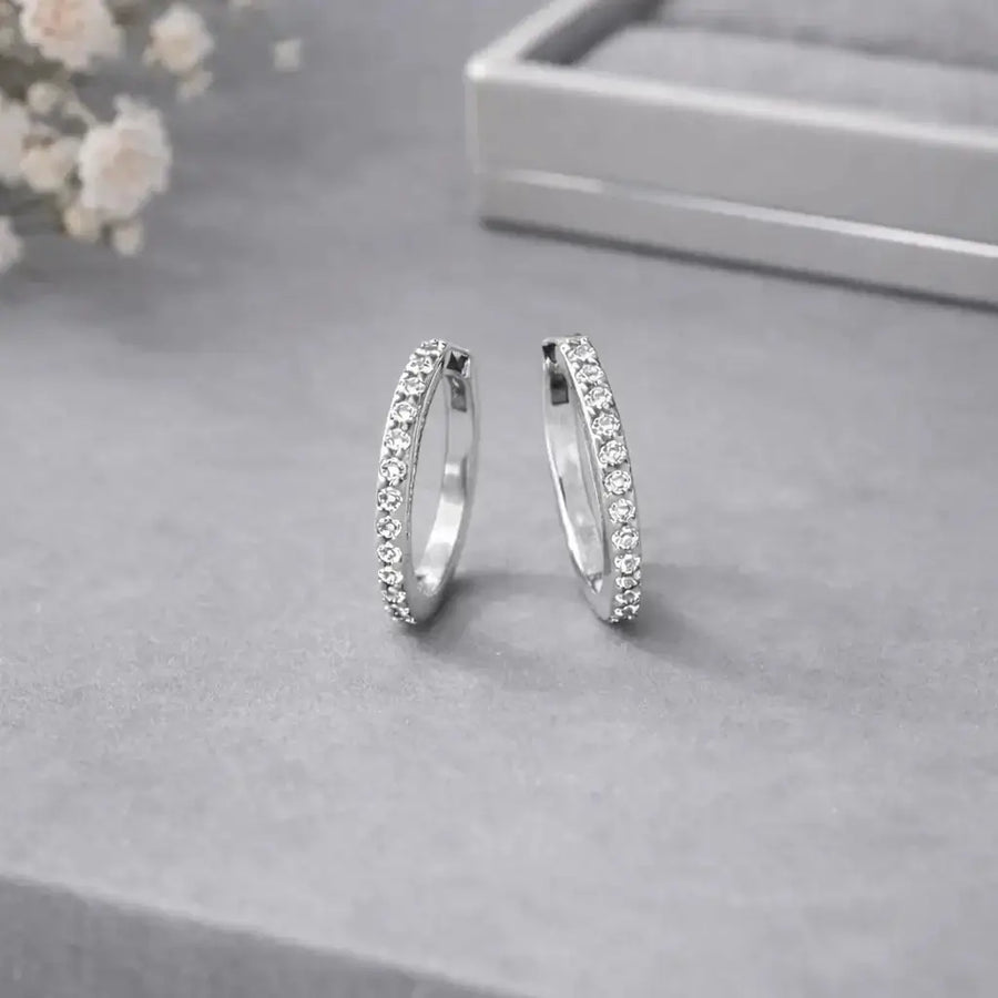 Everyday Diamond Huggies showcasing a pair of sparkly hoops adorned with tiny cubic zirconia stones.
