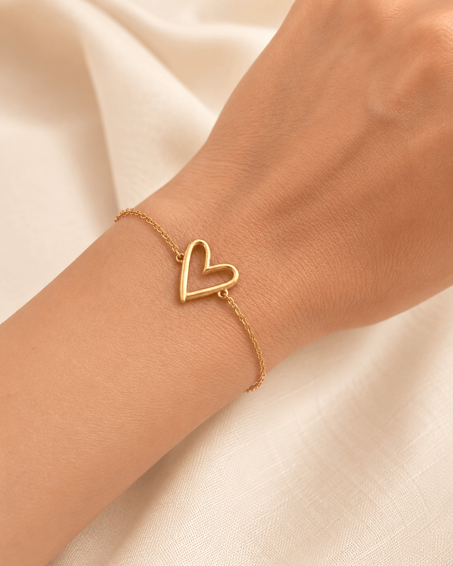 Mehr Heart Bracelet featuring a delicate open heart charm on a woman's wrist.